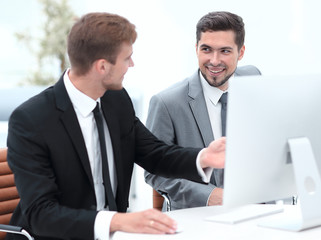 Fototapeta premium employees are talking sitting behind a Desk