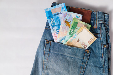 new Russian money banknotes of the Olympic and jubilee with a dollar bill in jeans pocket