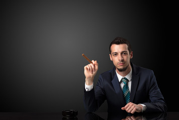 Businessman holding cigarette.