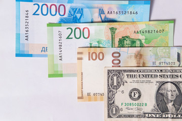 new Russian money banknotes and commemorative Olympic banknote with dollar on white background