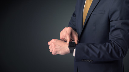 Man in suit wearing smartwatch.