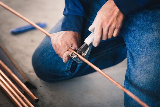 Industry system men worker cut joint with tool of copper pipe air conditioner