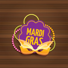 vector new orleans mardi gras carnival label with mask and text on wooden wall background. vector mardi gras party or fat tuesday poster design template