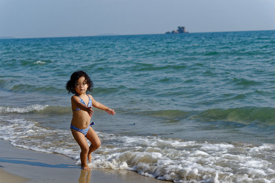 little girl on the beach in summer Thailand