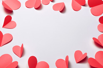 Beautiful pink paper hearts on white paper background