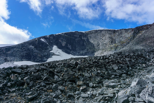 Reflection of mountain chain in a small lake in Jotunheimen national park in Norway