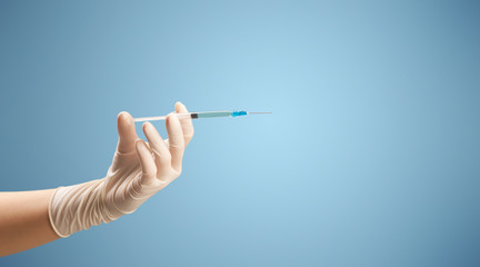 Female doctor holding syringe