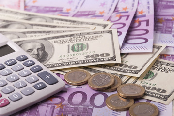 Dollar, euro banknotes, coins, calculator