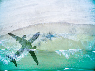 Aerial View of lonely beach with shadow of airplane