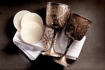 Sacramental bread and silver chalice cups