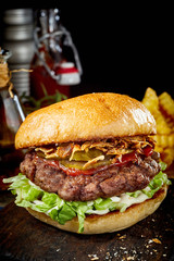 Thick juicy beef burger with ham and ketchup