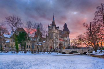 Vajdahunyad castle in Budapest, winter evening , entrance with stone bridge