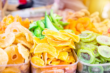 Stand with tasty dried fruits. Kiwi, Pineapple, Orange. Colorful street food with sweet tasty delicious candies in Venice, Rialto Market in Italy.