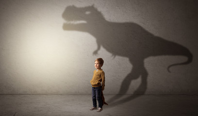 Dinosaurus shadow behind cute boy © ra2 studio