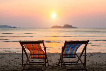 Loungers at the seaside at amazing sunset.