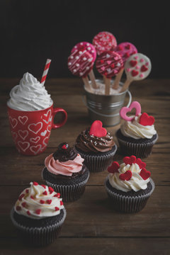 Served romantic cake pops and cupcake on the table,selective focus and valentines day concept