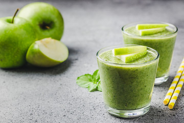 Green tea apple smoothie on concrete background. Selective focus, space for text. 