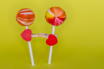 red heart attached to a stick candy, a clothespin, and it's like a man in love