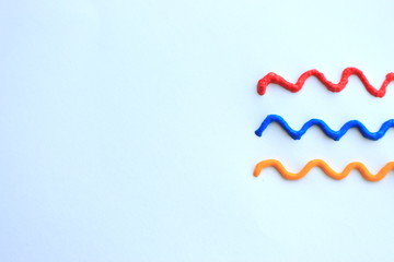 Colorful waving lines on paper with copy space. Red, blue and yellow lines. Abstract background. Art abstract. Graphic colorful background.