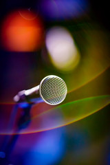 Microphone on stage against a background of auditorium.
