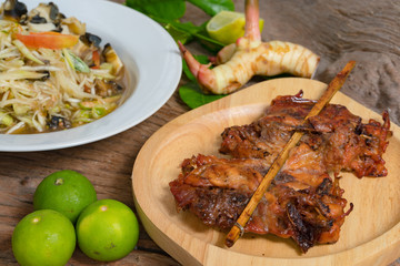 Grilled chicken served with papaya salad.