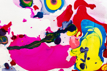 Colorful ink splashes on white paper abstract texture background.