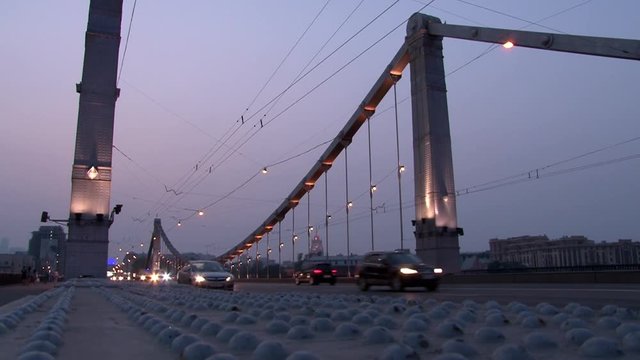 Car hanging bridge over river in evening Moscow. Beautiful views of capital Russia . Steel construction in big city.