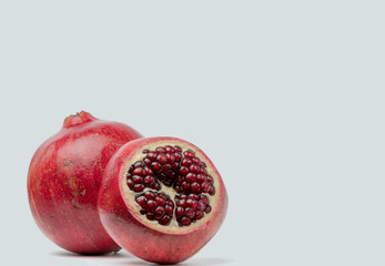 Big Ripe Red Granets or Garnets. Fruits of Red Ripe Pomegranate on the White Background.