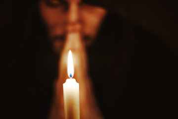 a monk with a candle
