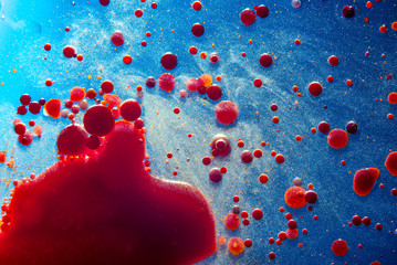 Red bubbles of blood cells on blue background closeup. Abstraction of medicine. Concept of micro...