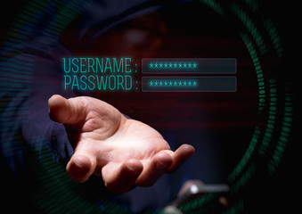 Hooded cyber crime hacker using mobile phone and internet hacking in to cyberspace for username and...