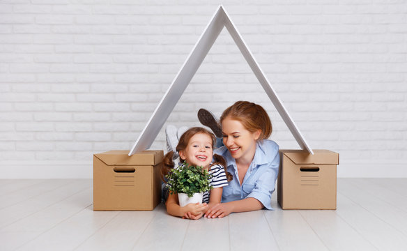 concept of housing, mortgage and relocation family mother and child with roof and boxes