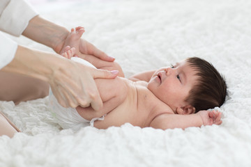 Fototapeta na wymiar baby is enjoying massage from mother