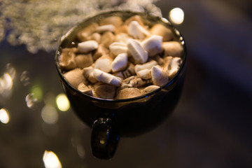hot chocolate in a large glass mug with marshmallow