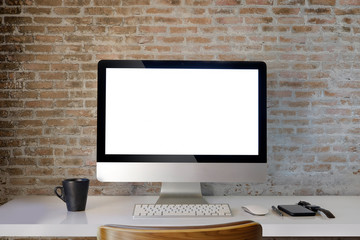 Fototapeta premium Workspace mockup with desktop computer red brick wall and office supplies. blaink screen monitor for graphic display montage.