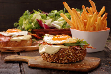 Sandwich with cheese bacon and fried egg