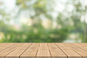 Empty wood table top on nature green blurred background at garden,space for montage show products