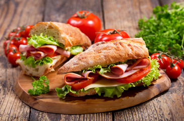 two sandwiches with ham and vegetables