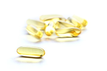 Close up yellow Cod Liver Oil capsule on white background, fish oil is a dietary supplement derived from liver of cod fish, have omega-3 fatty acids, EPA, DHA, vitamin A and D