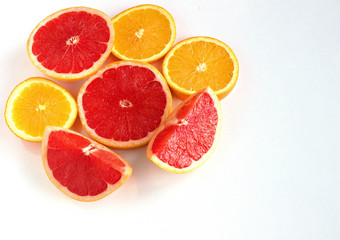 Slices oranges fruit and grapefruit on white background copy space