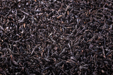 Background with black tea with copy space. Selective focus.