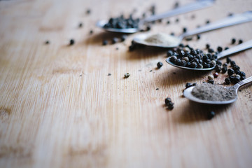 Various types of pepper on a wooden background