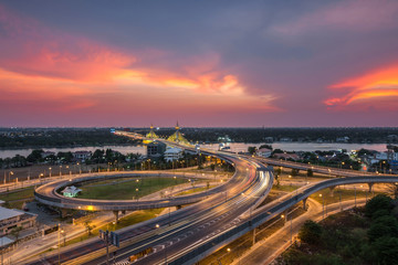 Fototapeta na wymiar Long exposure light road on expressway with beautiful sunset, Nonthaburi bridge, Thailand