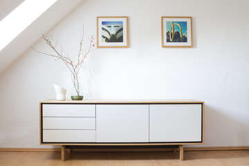Modern sideboard in bright living room - obrazy, fototapety, plakaty