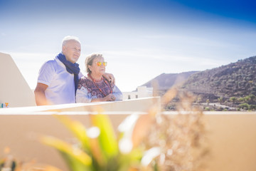 elderly couple on the rooftop looking at panorama