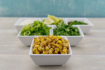 Roasted Corn in White Bowl On Bare Table