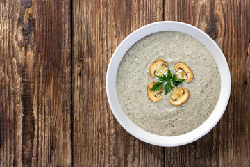Mushroom cream soup on a wooden table. Top view.