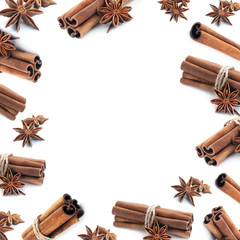 Cinnamon stick group frame with star anise spice isolated on white background