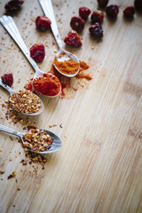 Various hot spices on a wooden background