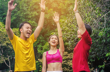 Three happy friends having a sports greeting afther workout at the park.